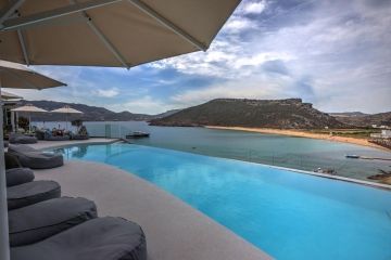 Panormos Village zwembad met loungebedden